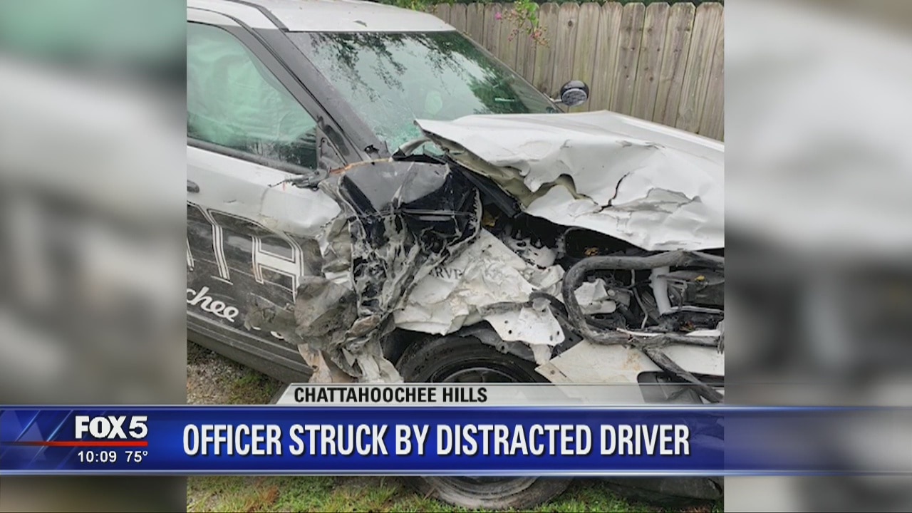 Distracted driver strikes officer