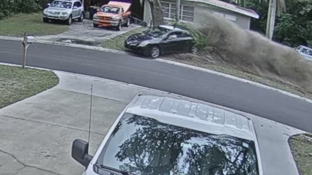 Car loses control and narrowly misses man in driveway