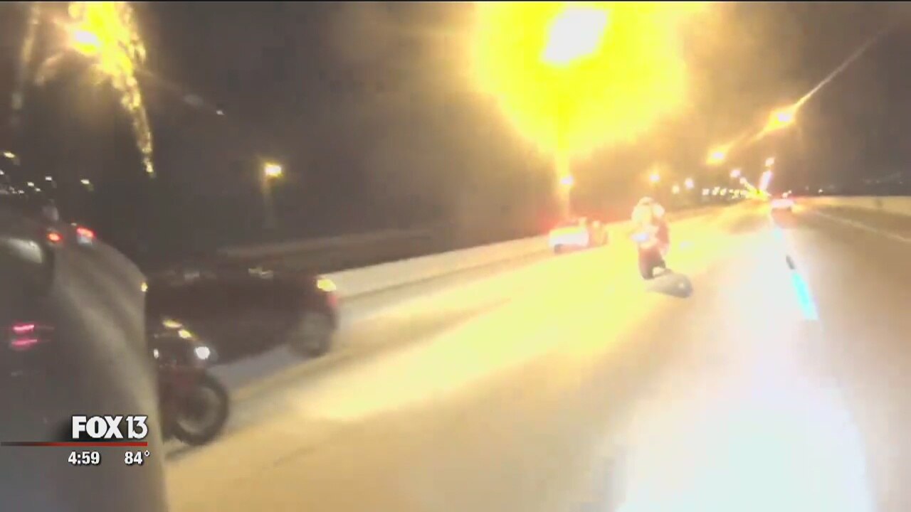Video: Motorcyclists, driver tangle on bridge