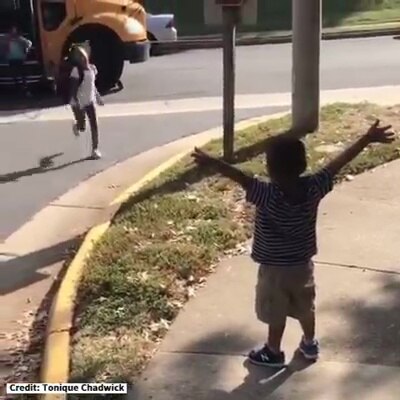 Toddler excitedly greets big sister with hugs every day at school bus stop
