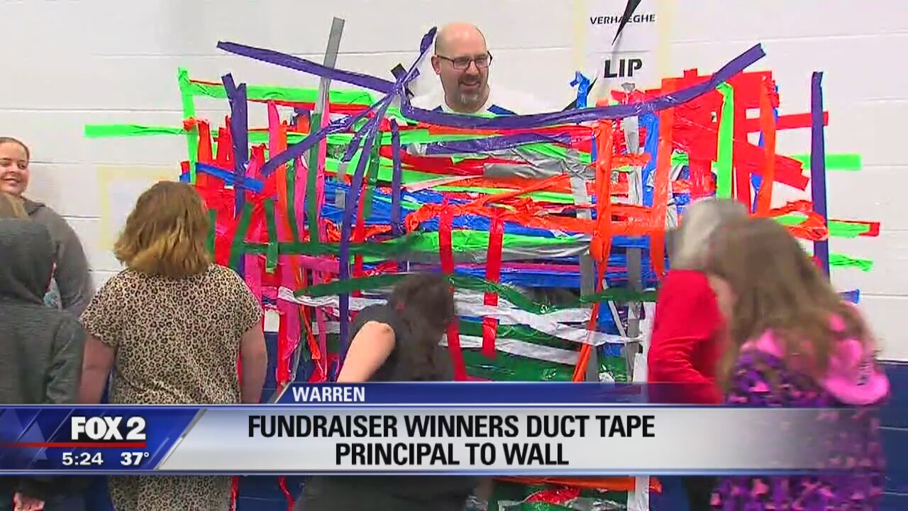 Fundraiser Winners duct tape principal to wall
