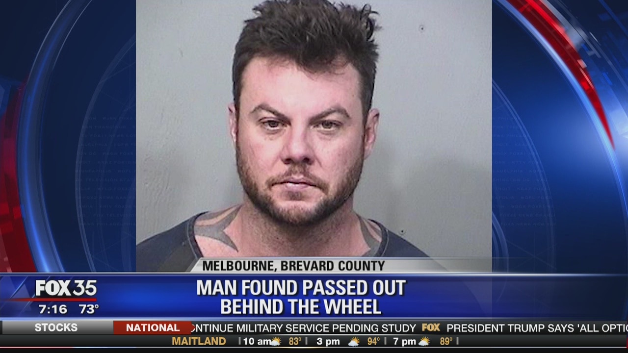 Man found passed out behind the wheel