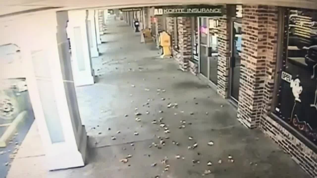 Deer runs through glass window into barber shop
