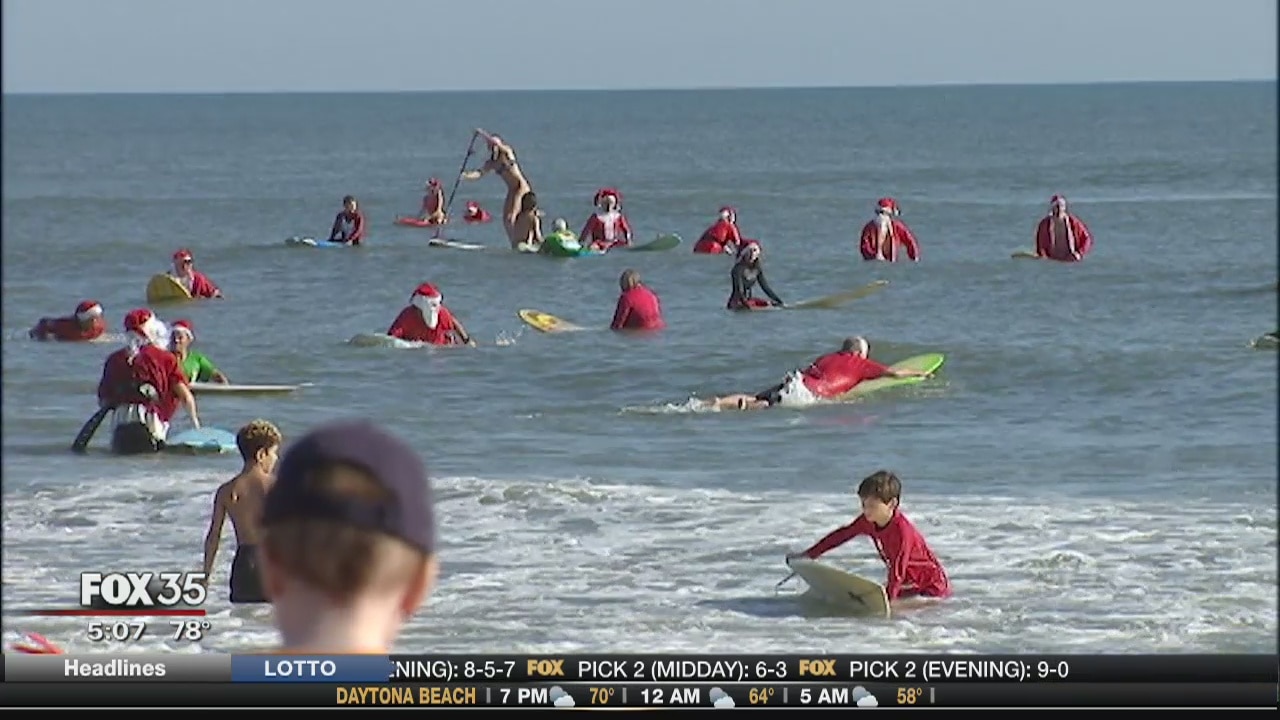 Crowds flock to beach for Surfing Santas