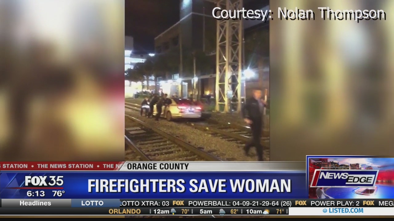 Orlando firefighters save woman who drove onto train tracks