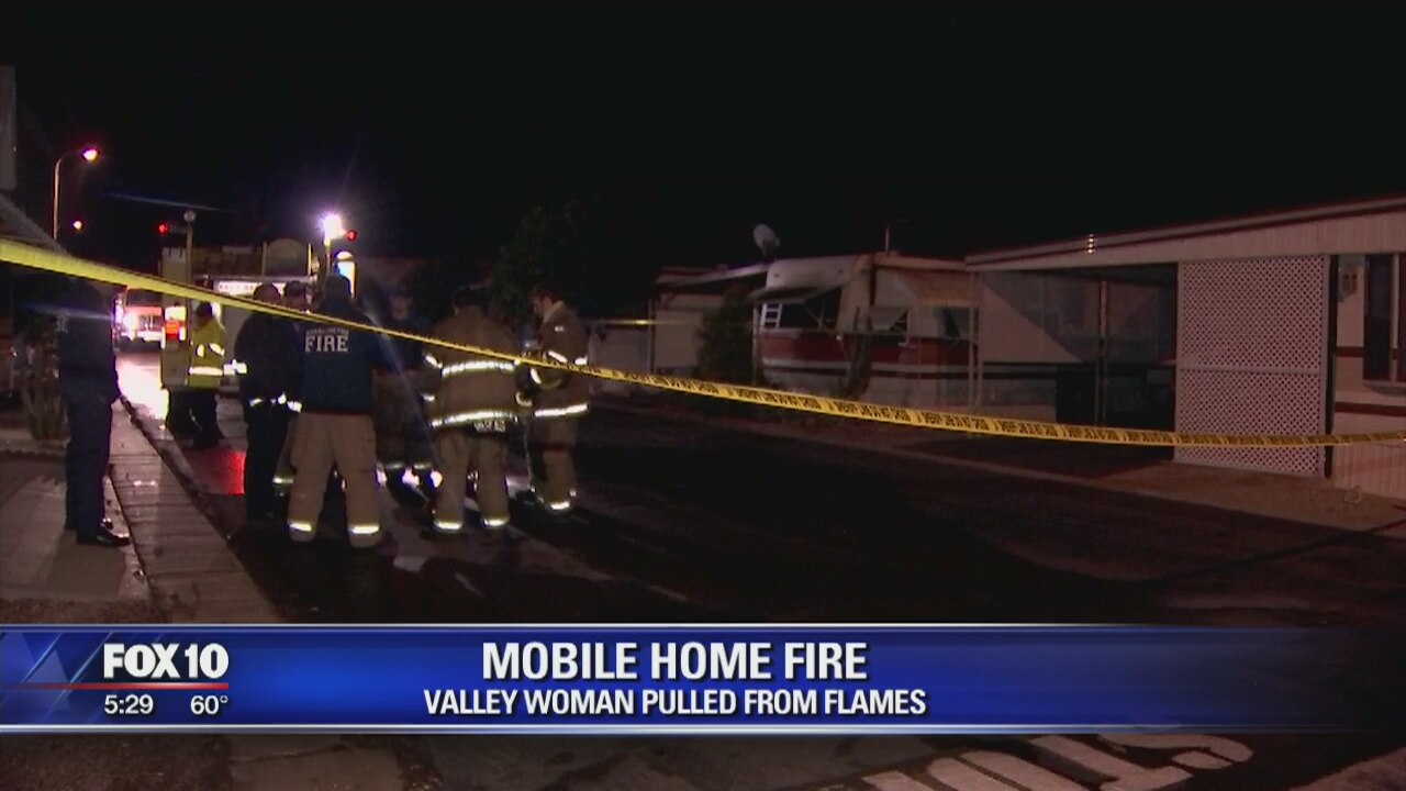 Woman pulled from burning mobile home