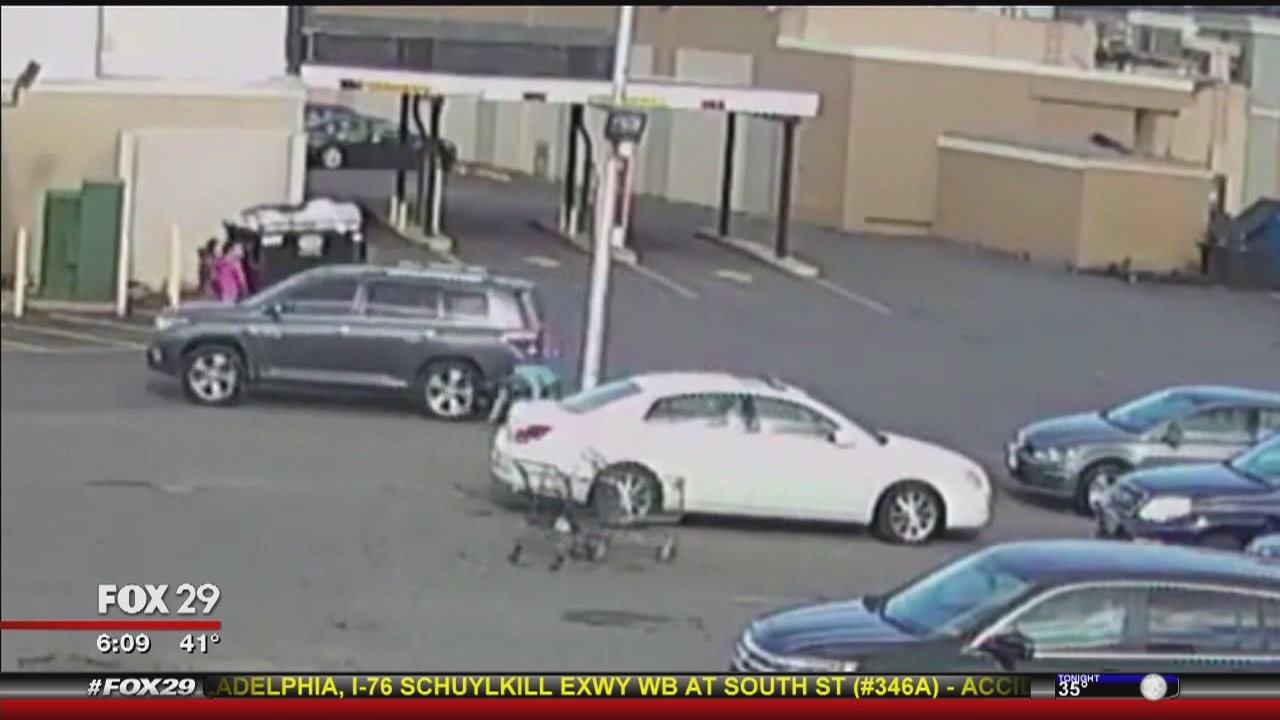 Shopper loading car dragged by alleged purse thief?s vehicle