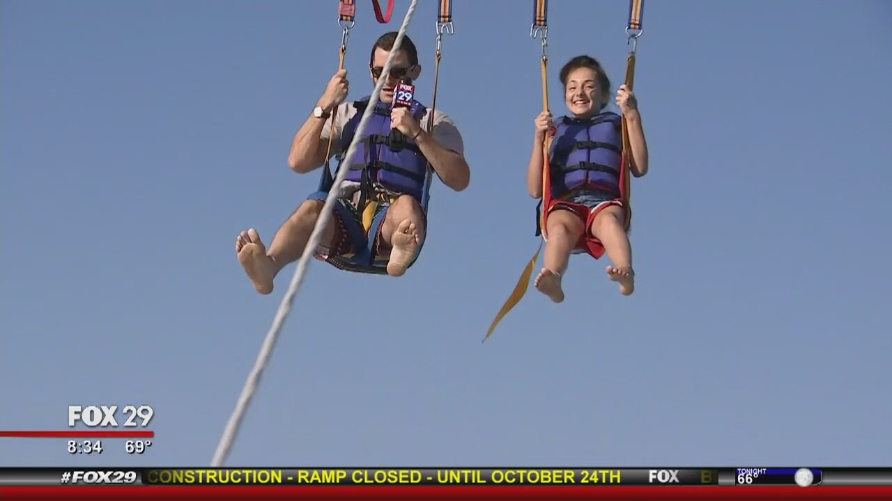 Richard Curtis tries parasailing with an 11-year-old girl