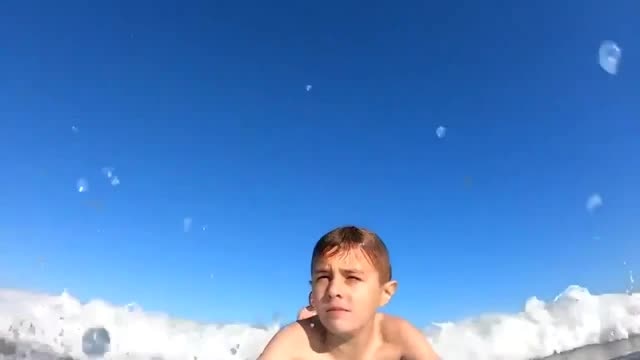 Watch shark knock boy off his surfboard