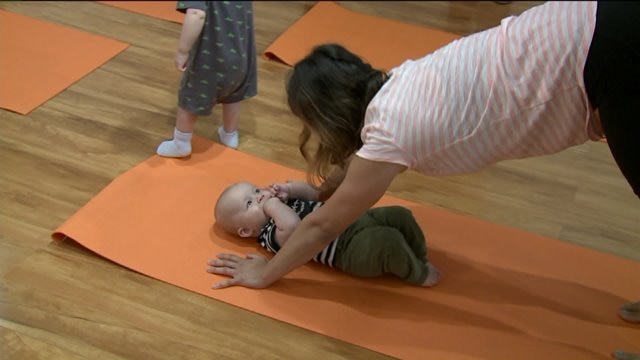 Kramp learns about baby yoga at Kith & Kin