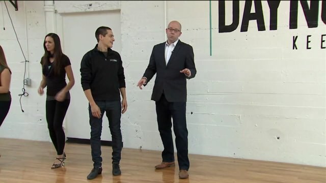 Kramp focuses on his footwork as he gets a lesson in Salsa dancing