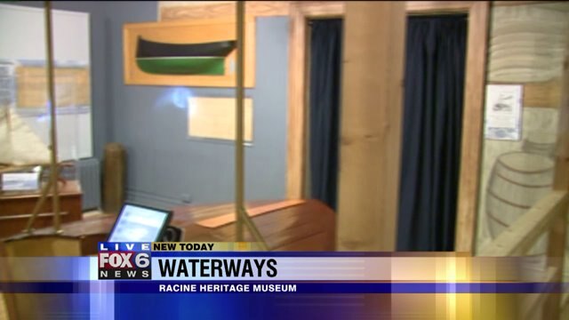 Justin hangs in Waterways exhibit Racine Heritage Museum
