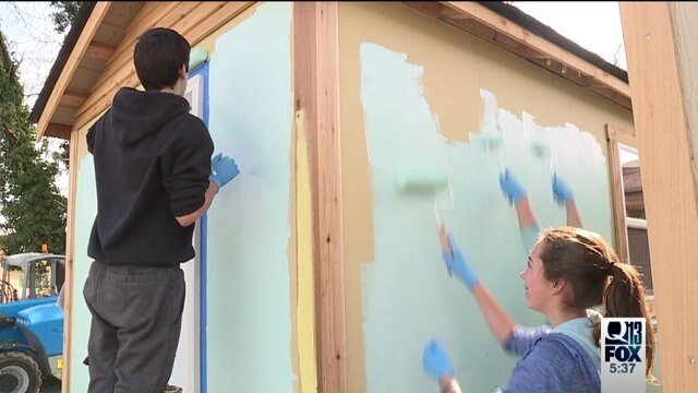 7th graders paint tiny houses