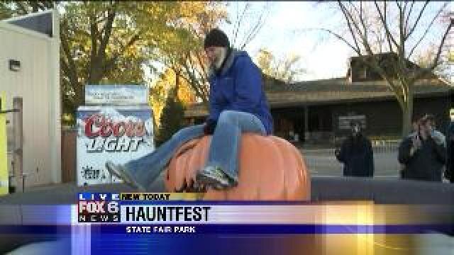 Laura has a blast riding a large pumpkin