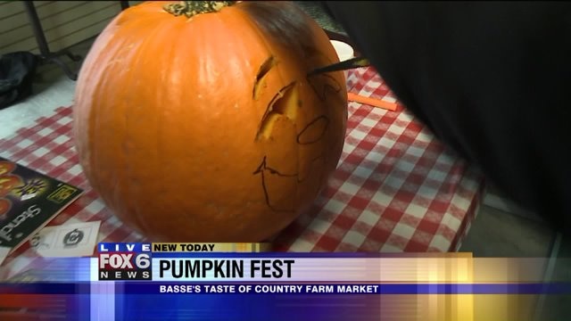 Laura has a blast carving pumpkins at Basses`s Taste of Country