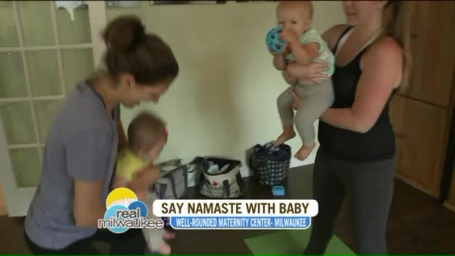 Chip learns different yoga moves at the Well-Rounded Maternity Center