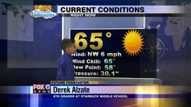 Derek Alzate helps Meteorologist Rob Haswell with the weather