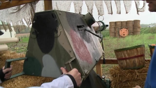 Laura has a blast trying out the pumpkin launcher