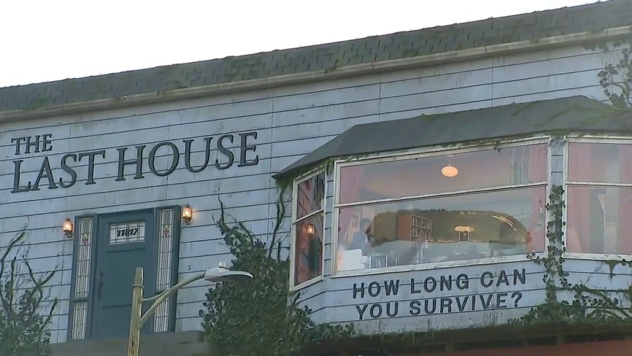 Man living inside billboard as part of Netflix movie promotion for "The Last House"