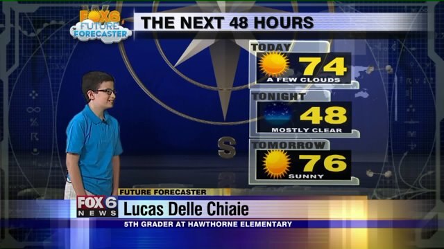 Lucas Delle Chiaie helps Meteorologist Rob Haswell with the weather