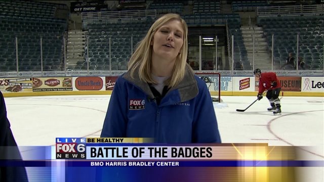 Laura works on her hockey skills as she previews Battle of the Badges