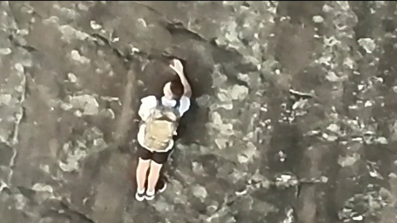 Firefighters rappel down mountain to reach trapped climber