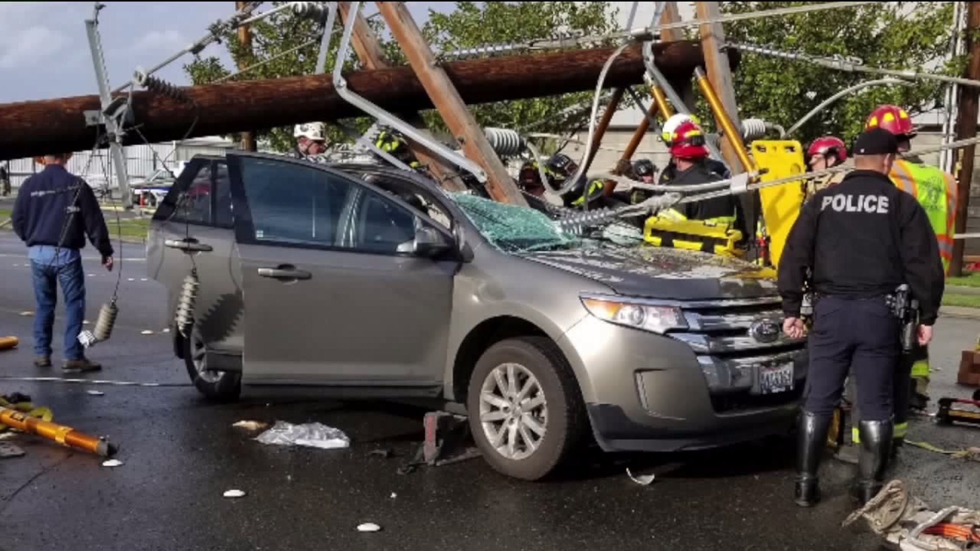 Power pole falls onto car in Tukwila