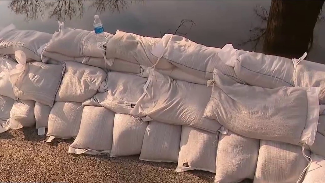 Volunteers stack sandbags as rivers in suburban Chicago near crest under flood warning
