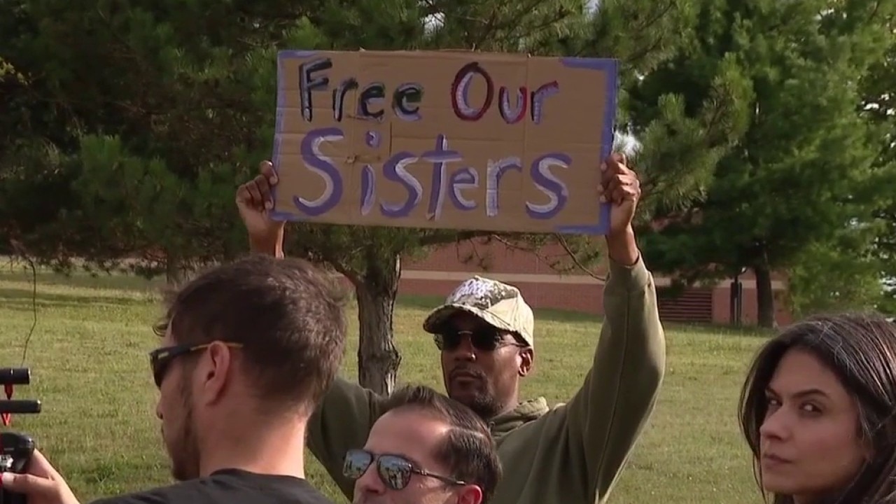 Families of women who died in prison hold vigil