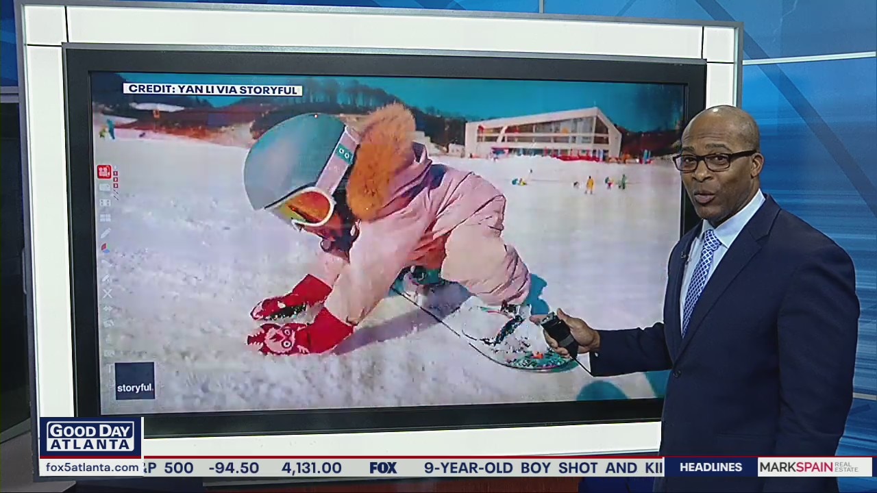 Determined 2-year-old girl practices snowboarding tricks