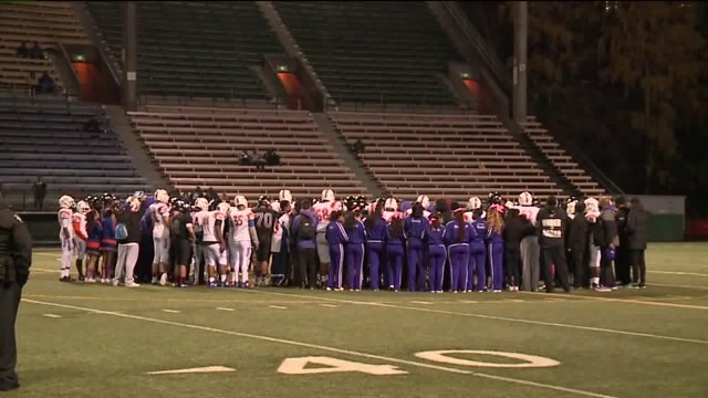 HS football team peace circle