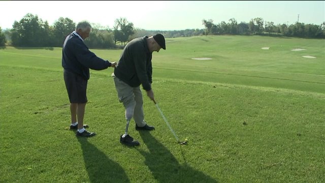 Chip talks with participant about First Swing