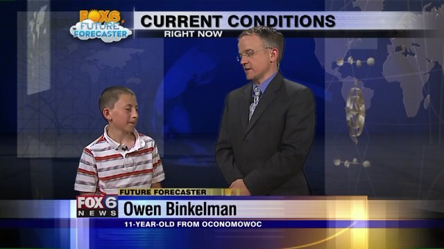 Owen helps Meteorologist Rob Haswell with the weather