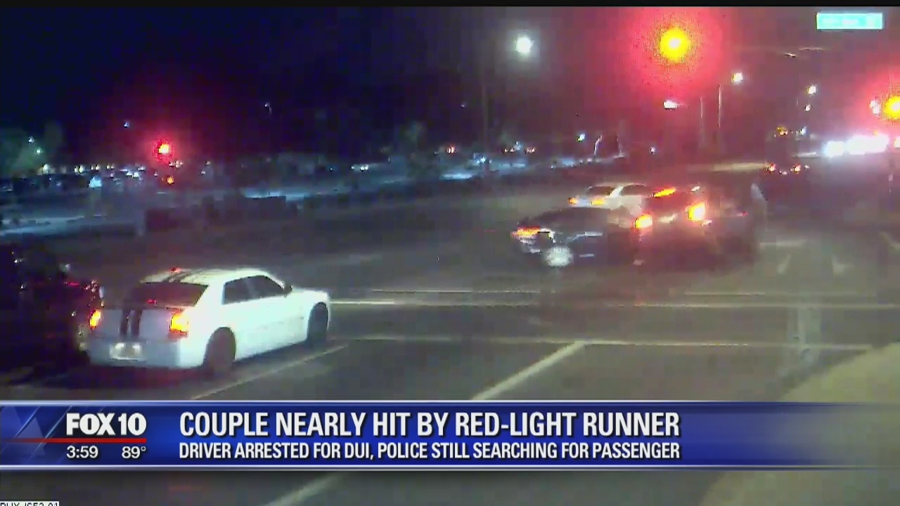 Car crashes into suspected drunk driver running red light, possibly saving couple's lives