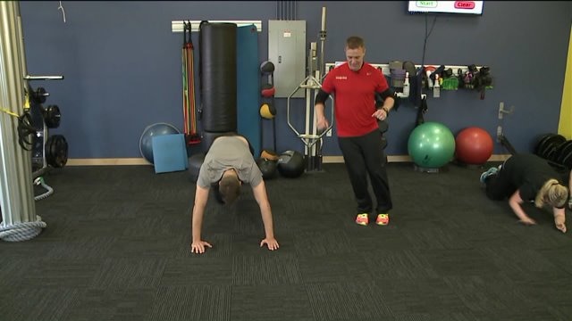Chip learns a workout routine at Orange Shoe Personal Fitness