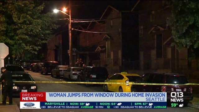 Woman jumps out of 3rd story window after four armed men break into her Seattle home