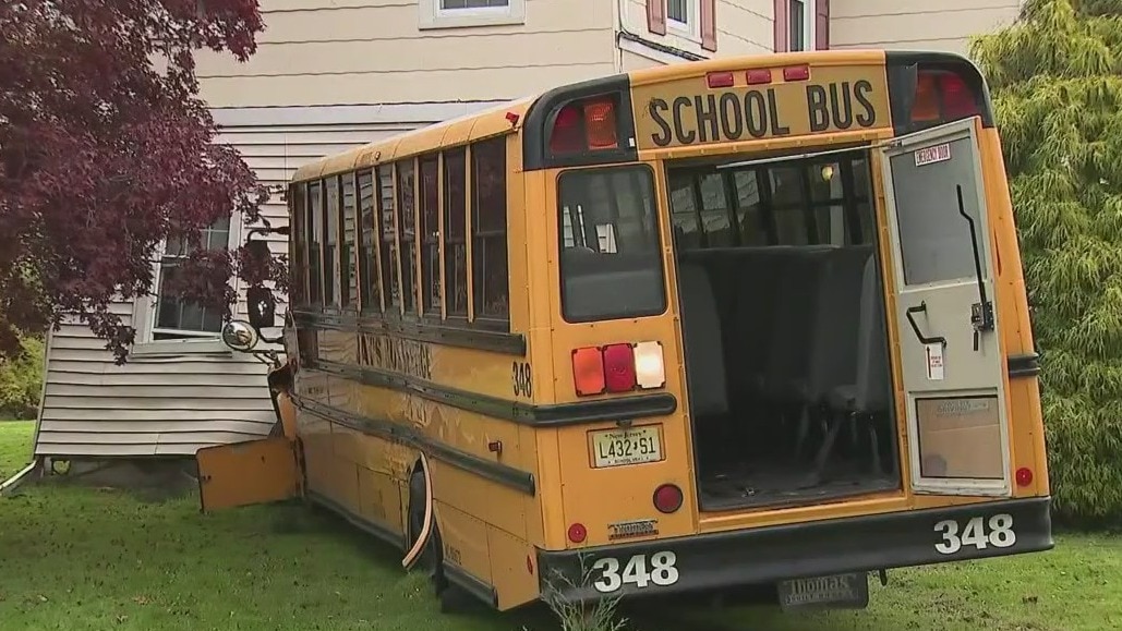 School bus crashes into home