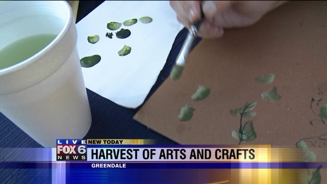 Laura checks out folk art at Harvest of Arts and Crafts