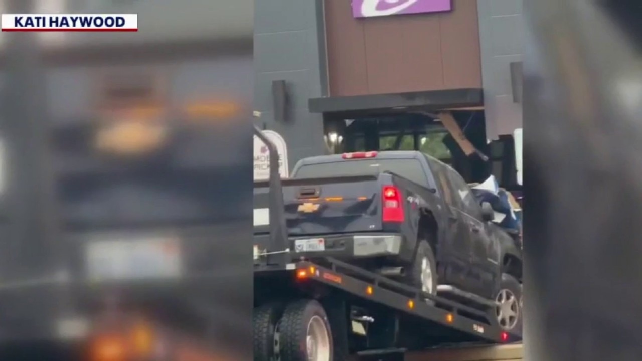 Truck runs through apartment sign, into Brownstown Taco Bell building