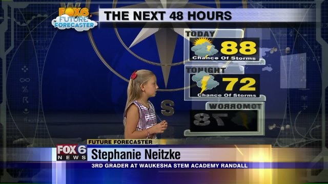 Stephanie Neitzke helps Meteorologist Rob Haswell with the weather