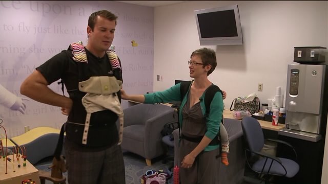 Chip learns how to put on a baby carrier