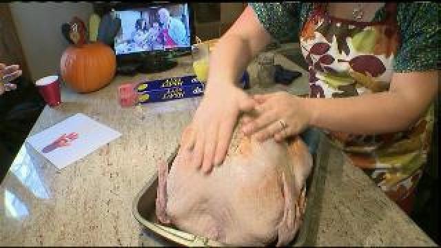 Tony helps the Mauldin family prepare their turkey