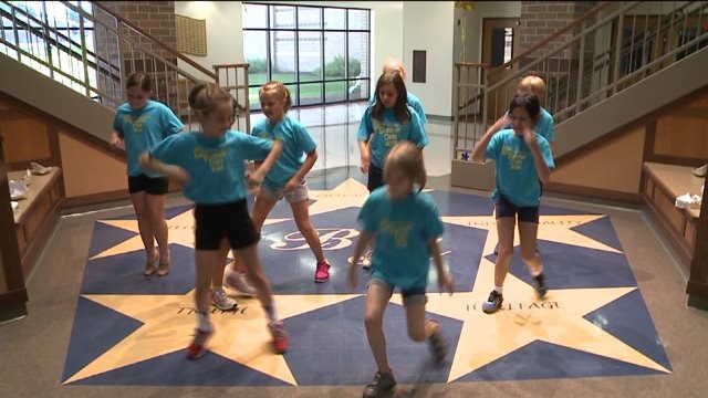 Chip talks with teacher, checks out dance routine