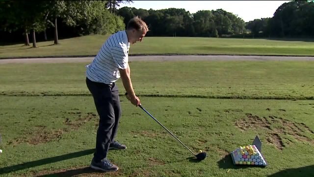 Carl talks with golf pro about PHC Classic