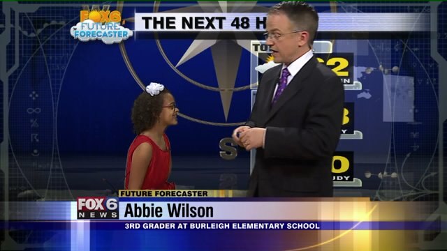 Abbie Wilson helps Meteorologist Rob Haswell with the weather