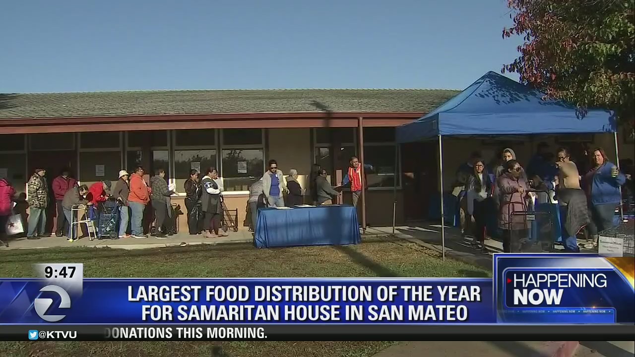 Samaritan House volunteers distribute food to those in need