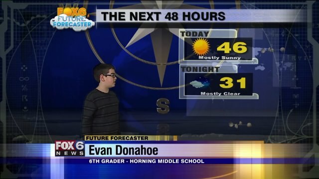 Evan helps Meteorologist Stephanie Barichello with the weather