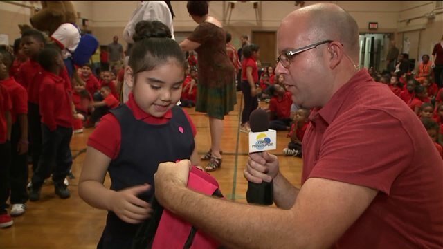 Brian Kramp helps hand out the Backpack Buddies
