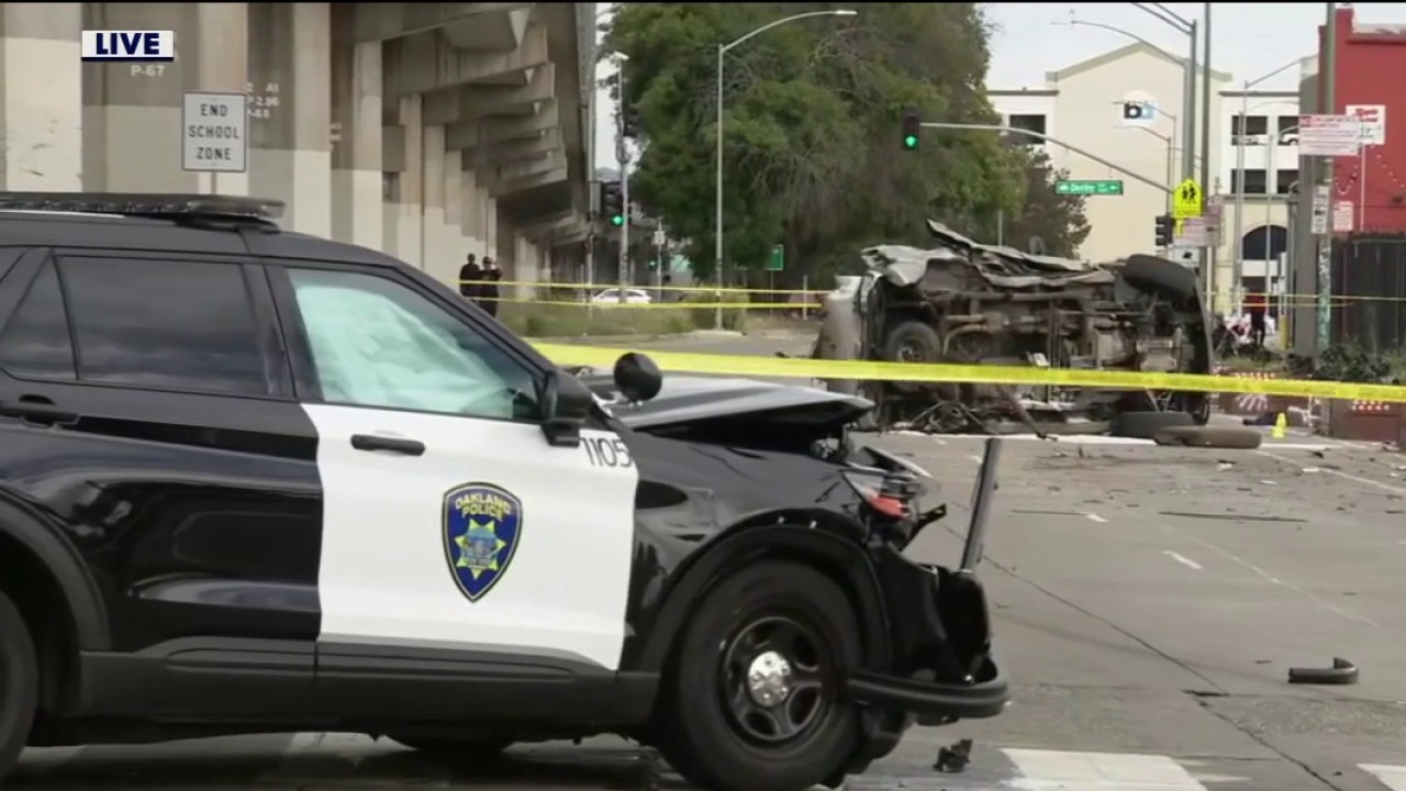 Driver held in crash that injures police officer and kills 2 passengers