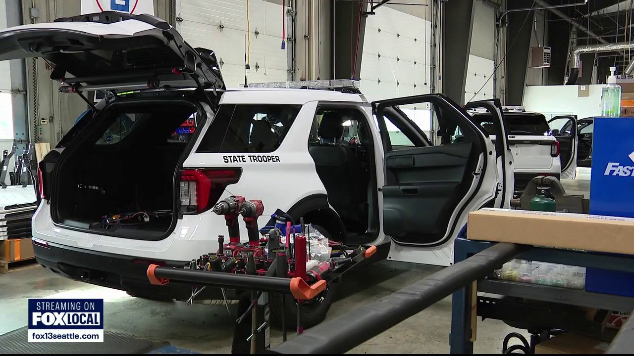 Inside the facility building Washington State Patrol cars